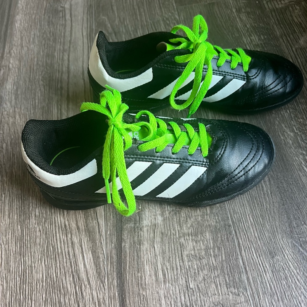 Black and bright green Adidas youth shoes. Size 2.